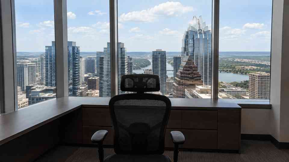 Austin-inspired virtual meeting background with an empty chair and desk behind it